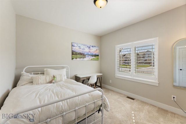 bedroom with baseboards, carpet, and visible vents