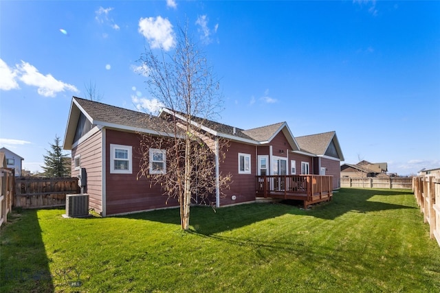back of house with a fenced backyard, central AC unit, a yard, and a deck