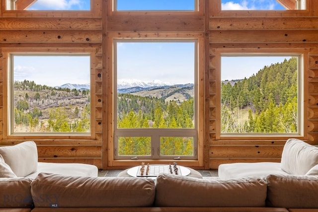 sunroom with a wooded view and a mountain view