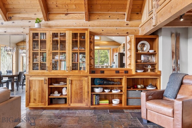 interior space with stone tile floors, beamed ceiling, and wooden ceiling