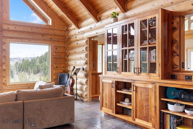 living area featuring stone tile floors, rustic walls, lofted ceiling with beams, and wood ceiling