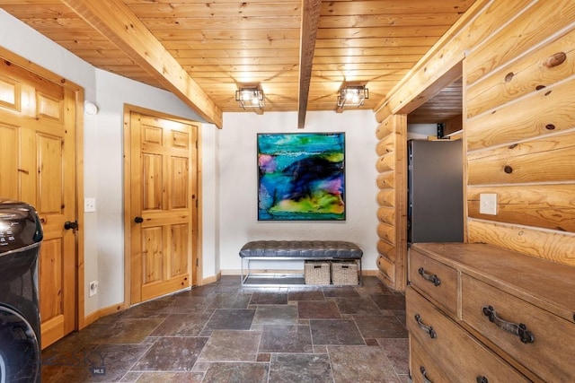 interior space featuring baseboards, wood ceiling, and stone finish flooring
