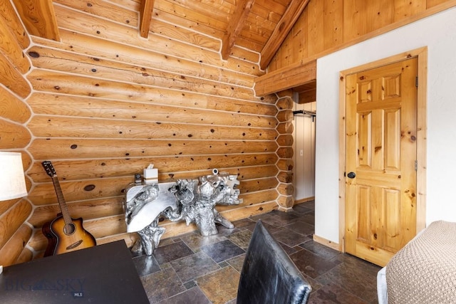 interior space with log walls, baseboards, vaulted ceiling with beams, wood ceiling, and stone finish flooring