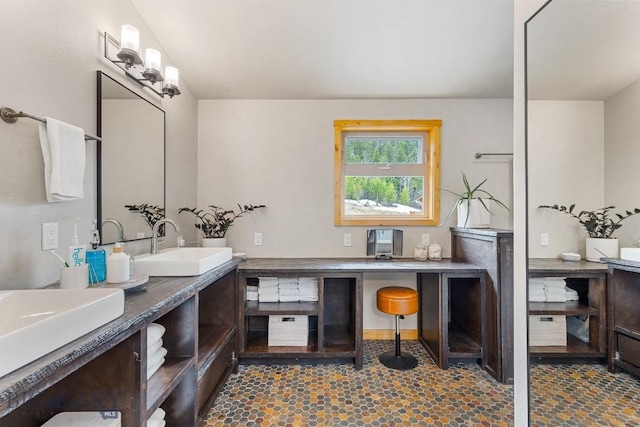 bathroom with double vanity and a sink