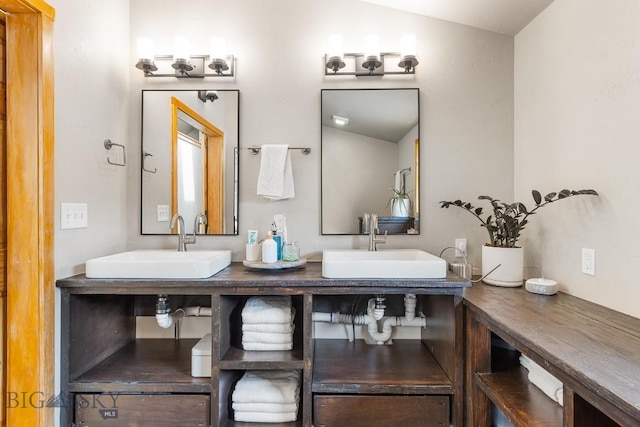 bathroom featuring double vanity, a sink, and vaulted ceiling