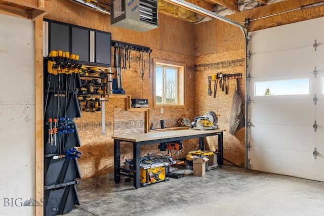 garage with a workshop area and a heating unit