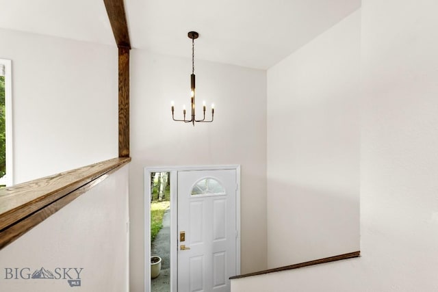 entrance foyer featuring an inviting chandelier