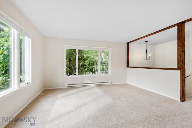 carpeted spare room with baseboards, a baseboard radiator, and a notable chandelier