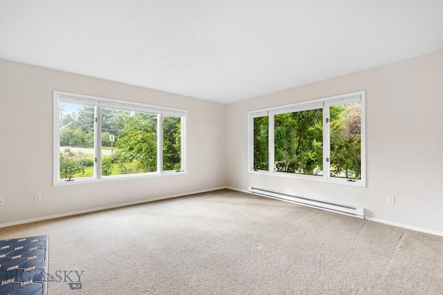 carpeted spare room featuring baseboards and a baseboard heating unit