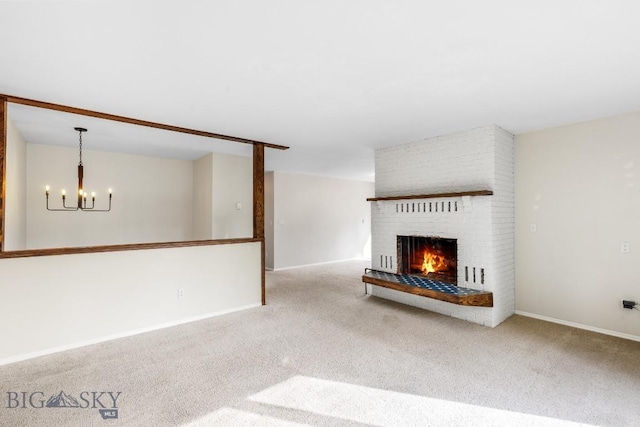 unfurnished living room with carpet floors, baseboards, a chandelier, and a fireplace