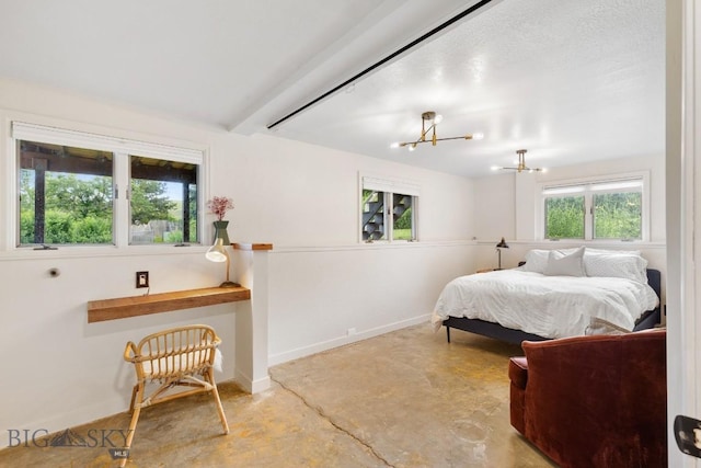 bedroom with baseboards, concrete flooring, and an inviting chandelier