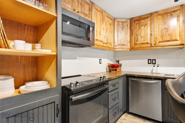kitchen featuring stainless steel appliances and gray cabinetry