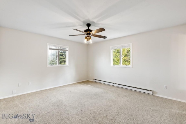 carpeted empty room with baseboards, a ceiling fan, baseboard heating, and a healthy amount of sunlight