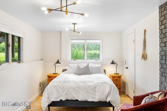 bedroom with wood finished floors and a notable chandelier