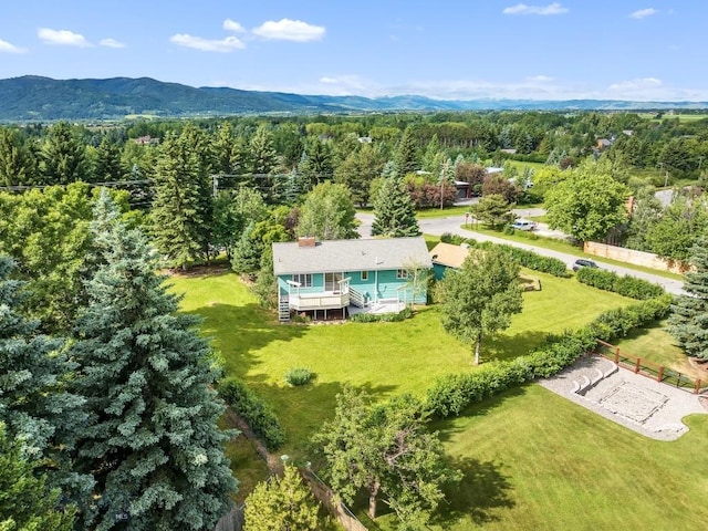 bird's eye view with a wooded view