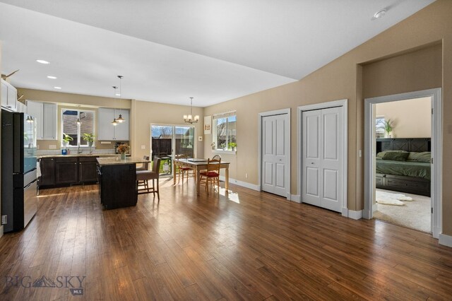 1604 Drummond Blvd, Belgrade, MT 59714 - dining space with an inviting chandelier, a wealth of natural light, and dark wood-style floors