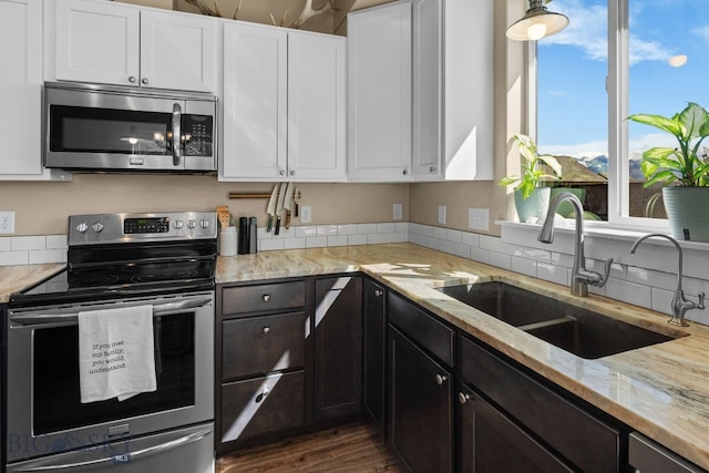 1604 Drummond Blvd, Belgrade, MT 59714 - kitchen with a sink, appliances with stainless steel finishes, light stone countertops, and white cabinetry