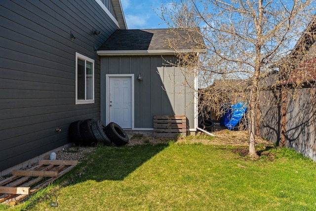 1604 Drummond Blvd, Belgrade, MT 59714 - property entrance featuring a lawn, fence, board and batten siding, and a shingled roof