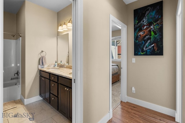 1604 Drummond Blvd, Belgrade, MT 59714 - bathroom featuring  shower combination, double vanity, baseboards, ensuite bathroom, and a sink