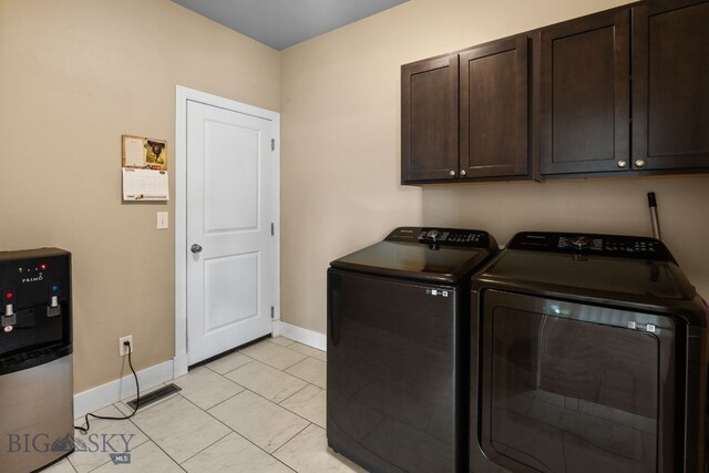 1604 Drummond Blvd, Belgrade, MT 59714 - washroom featuring baseboards, visible vents, cabinet space, and washer and clothes dryer