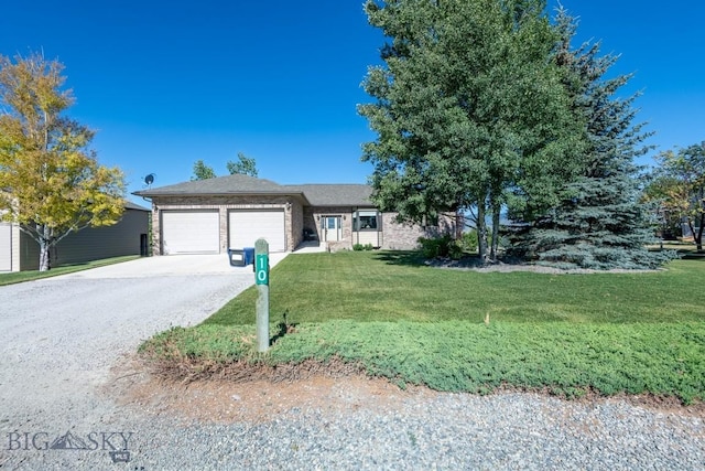 ranch-style house featuring brick siding, an attached garage, driveway, and a front lawn