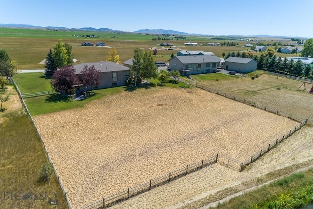 birds eye view of property with a mountain view and a rural view