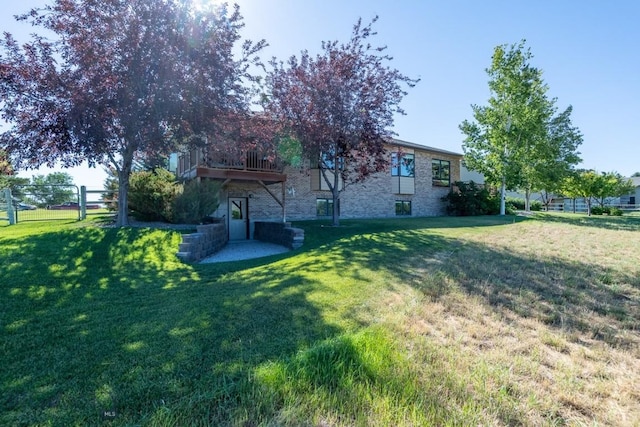 view of yard featuring fence and a wooden deck
