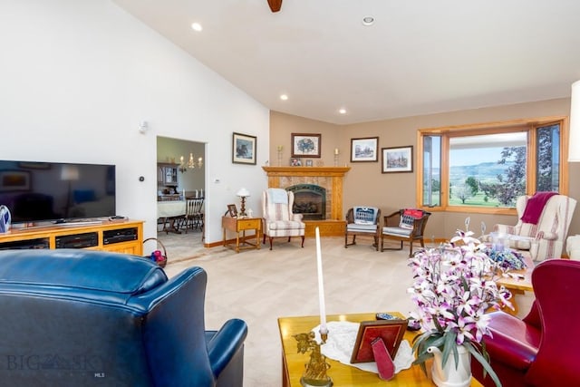 living area featuring lofted ceiling, baseboards, recessed lighting, a fireplace with raised hearth, and carpet