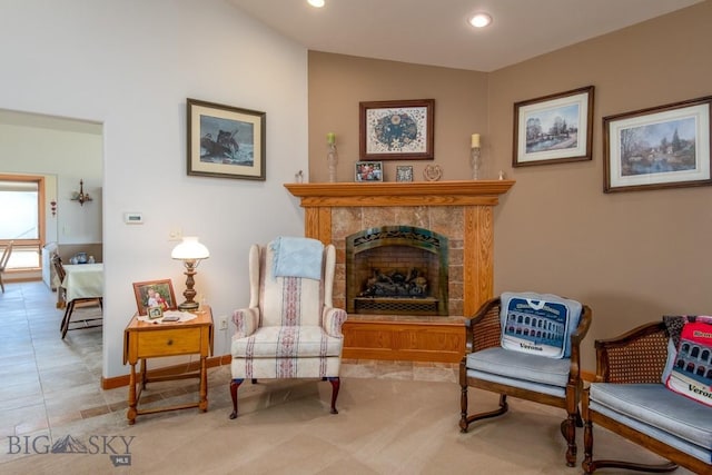 living area featuring baseboards, recessed lighting, a tile fireplace, and lofted ceiling