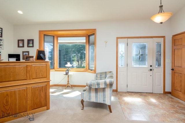 foyer entrance with baseboards and recessed lighting