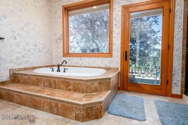 full bath with tile patterned flooring, a garden tub, and wallpapered walls