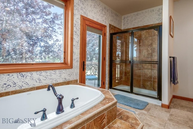 full bath featuring plenty of natural light, a stall shower, and a bath