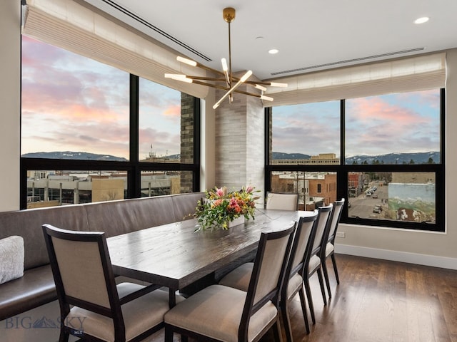 dining space with an inviting chandelier, baseboards, recessed lighting, and wood finished floors