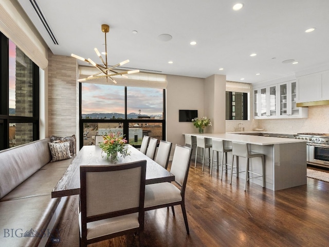dining space featuring recessed lighting, a notable chandelier, and wood finished floors