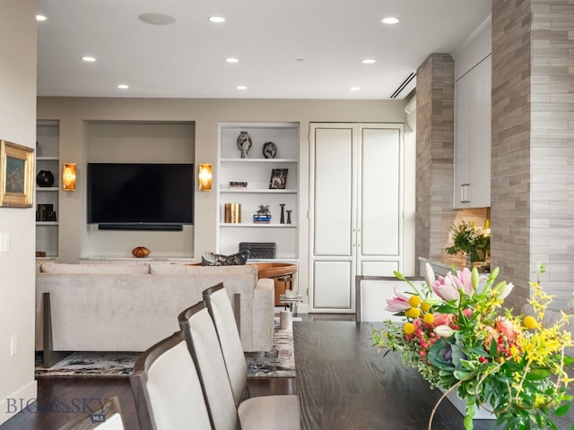 living area featuring recessed lighting and built in shelves