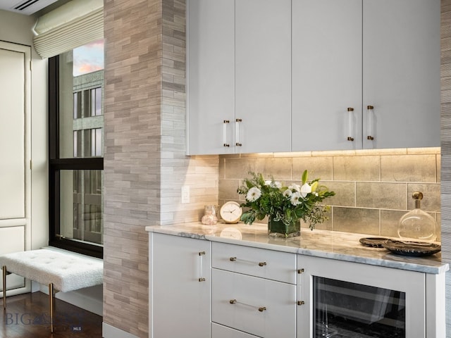 bar with decorative backsplash and beverage cooler