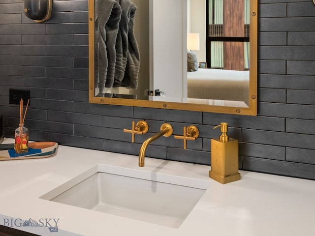 room details with decorative backsplash and a sink