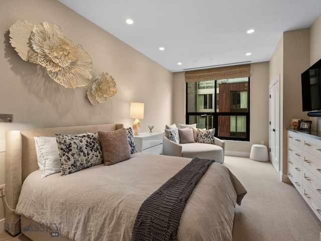 bedroom featuring light colored carpet, recessed lighting, and baseboards