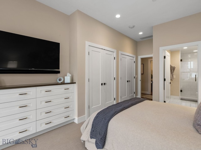 bedroom with visible vents, multiple closets, ensuite bathroom, baseboards, and recessed lighting