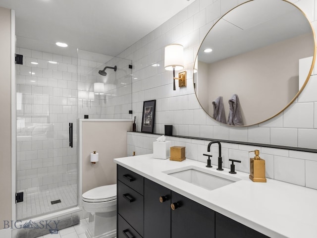 full bathroom with vanity, toilet, tile walls, tasteful backsplash, and a shower stall