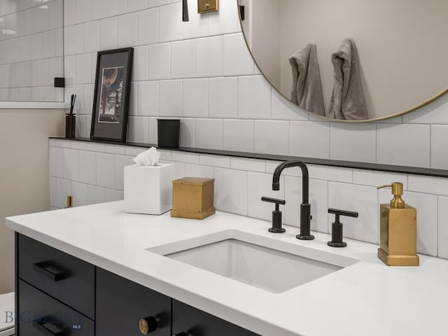bathroom with vanity and tasteful backsplash