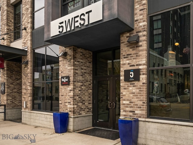 property entrance featuring brick siding