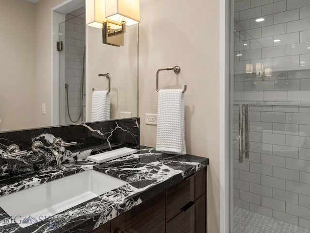 full bath with a shower stall and vanity