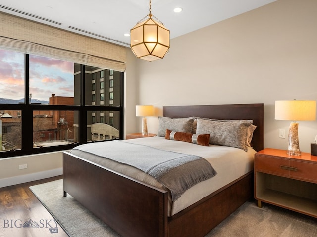 bedroom with baseboards, multiple windows, recessed lighting, and wood finished floors