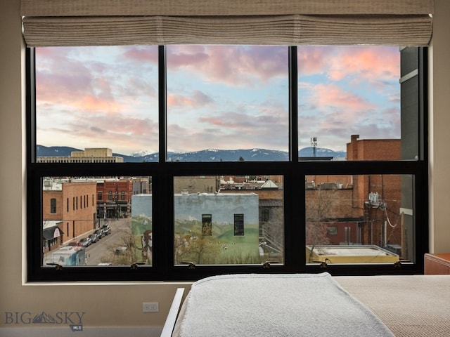 bedroom with multiple windows and a mountain view