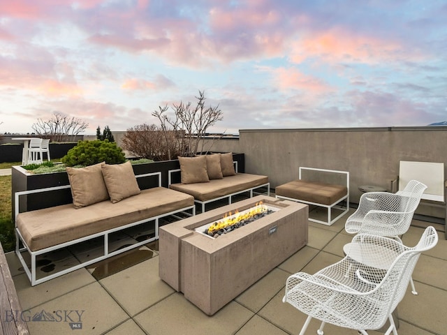 view of patio featuring an outdoor living space with a fire pit