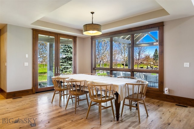 dining area featuring french doors, light wood-style flooring, baseboards, and visible vents