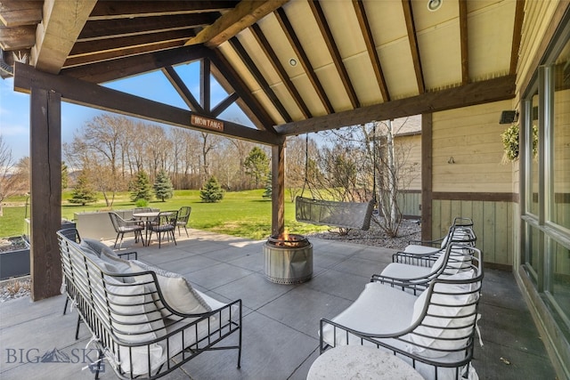 view of patio featuring a gazebo, outdoor dining area, and an outdoor fire pit
