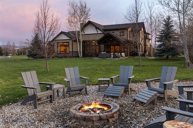 yard at dusk with a patio and a fire pit