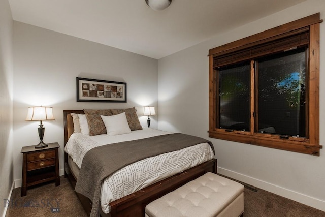 carpeted bedroom featuring baseboards